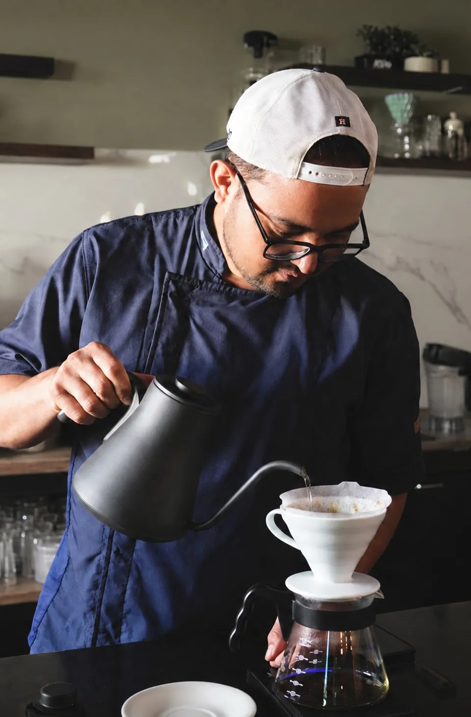 Salomon pouring coffee at Avenida Café Bistro